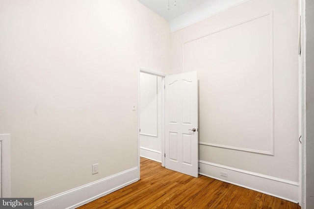 spare room with hardwood / wood-style flooring