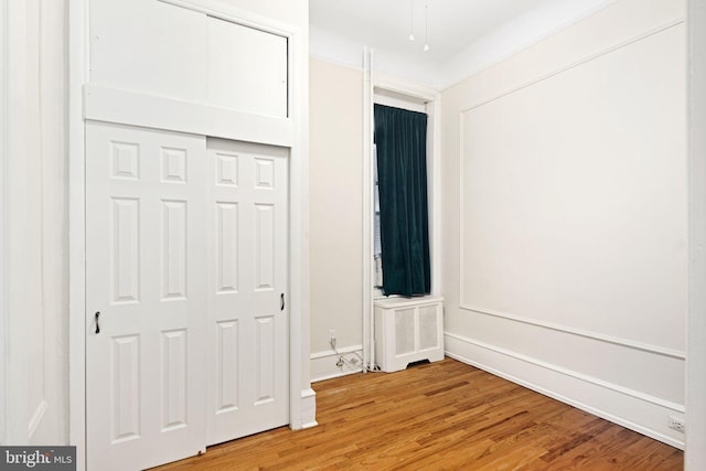 unfurnished bedroom featuring a closet and hardwood / wood-style floors