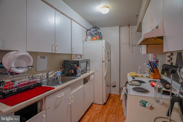 kitchen featuring white cabinets, white appliances, light wood-type flooring, and sink