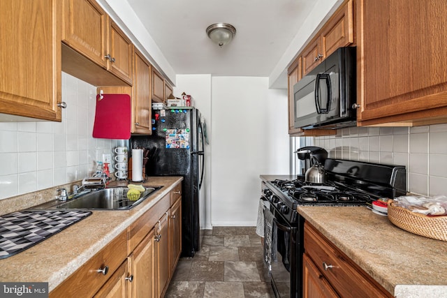 kitchen featuring sink, backsplash, and black appliances