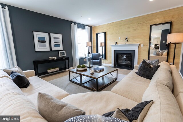 living room featuring wooden walls and light hardwood / wood-style floors