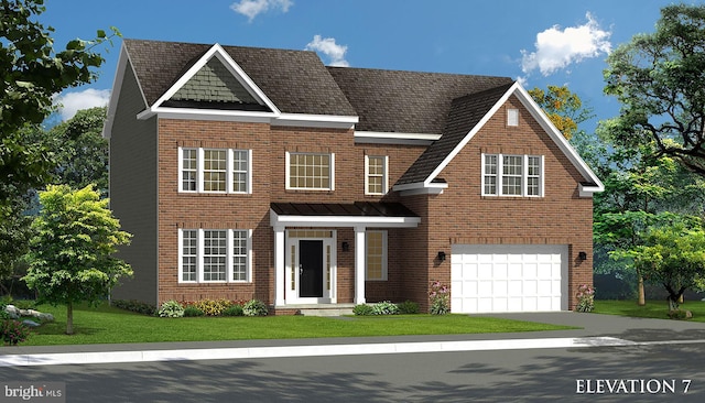 view of front of home with a front yard and a garage