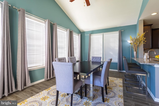 dining area with ceiling fan, lofted ceiling, and sink