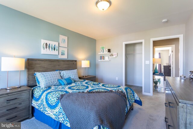 bedroom with light colored carpet and a closet