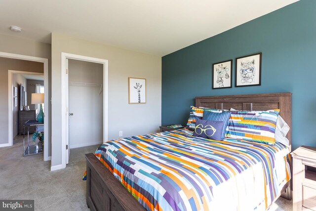 bedroom featuring light carpet and a closet