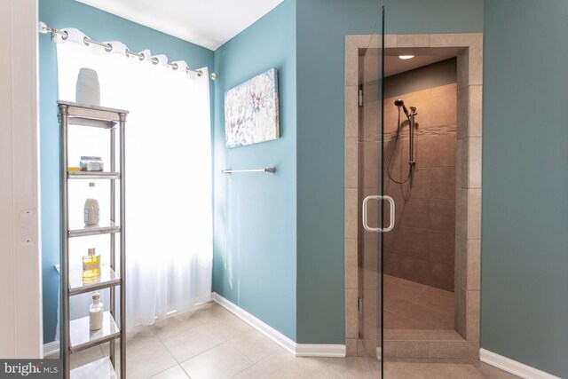 bathroom featuring tile patterned floors and a shower with door