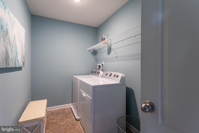 washroom featuring washer and clothes dryer and tile patterned flooring