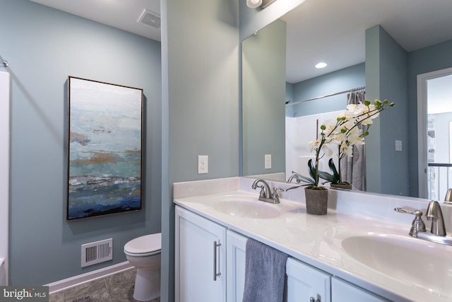 bathroom with vanity and toilet