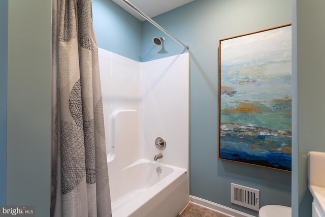 bathroom with shower / tub combo and toilet