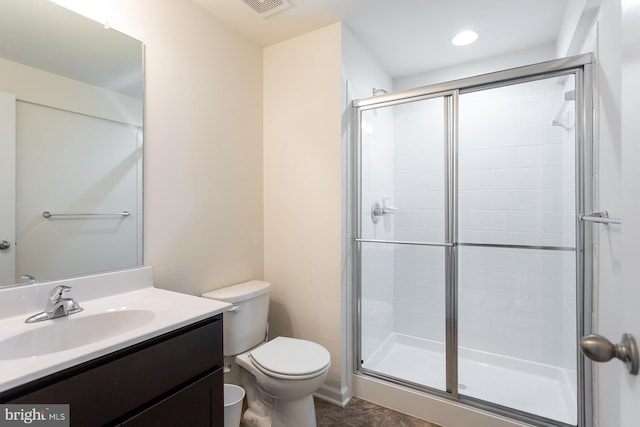 bathroom featuring toilet, vanity, and walk in shower