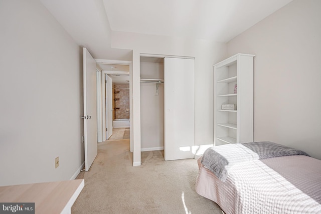 bedroom with a closet and light colored carpet