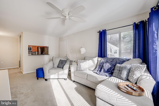 carpeted living room with ceiling fan