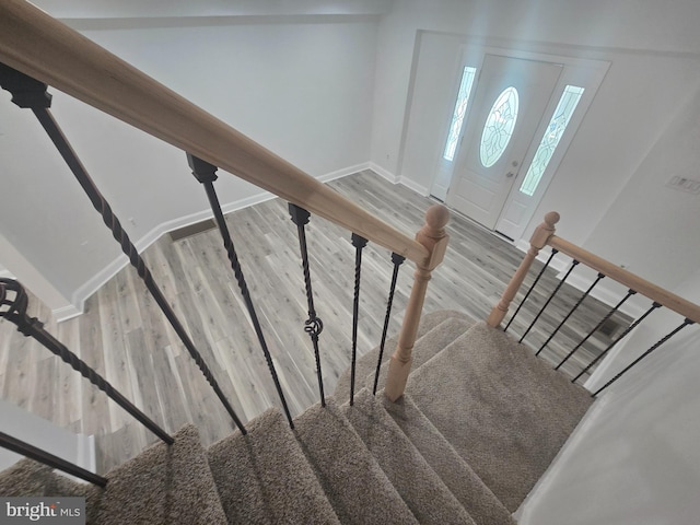 stairs featuring wood-type flooring