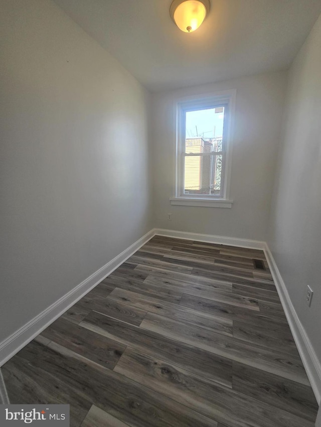 spare room with dark hardwood / wood-style floors