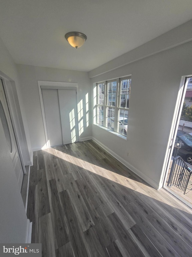 unfurnished room featuring dark hardwood / wood-style flooring