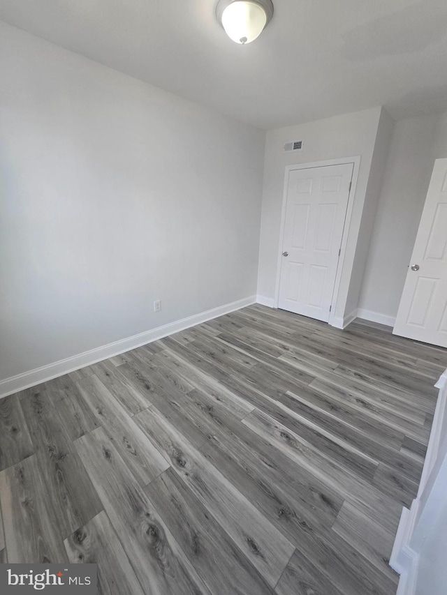 empty room featuring dark hardwood / wood-style flooring