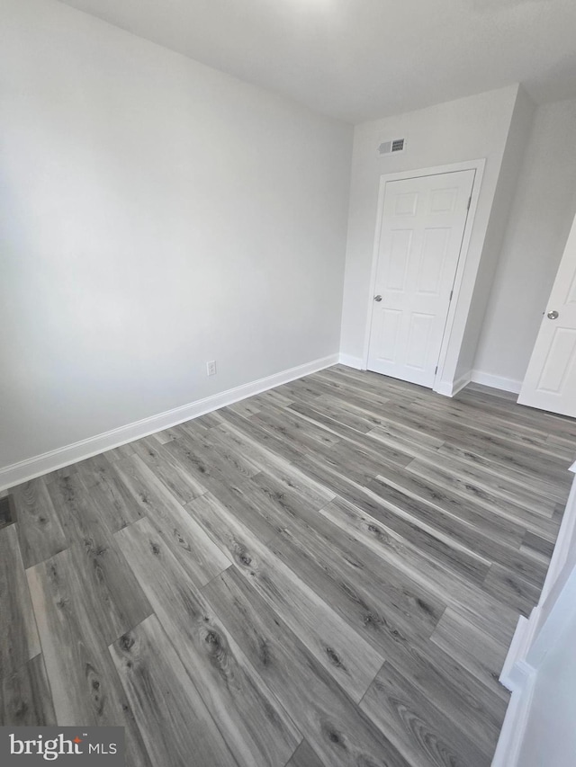 unfurnished room featuring wood-type flooring