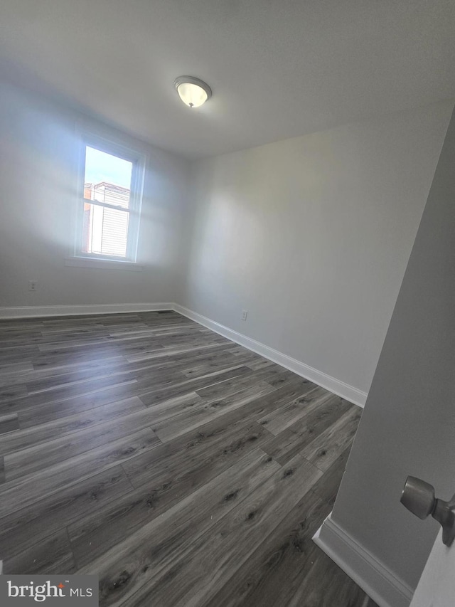 spare room featuring dark hardwood / wood-style flooring