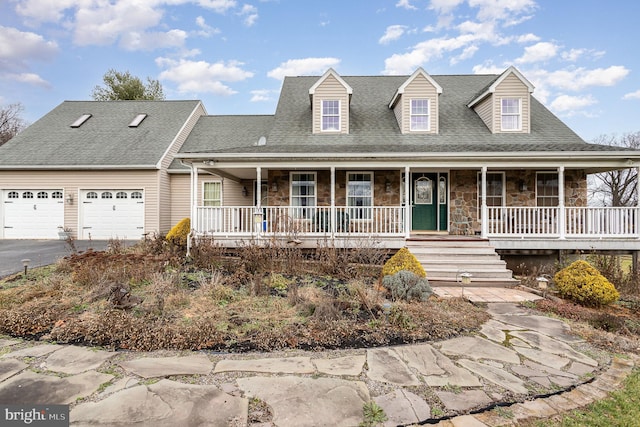 new england style home with a porch and a garage