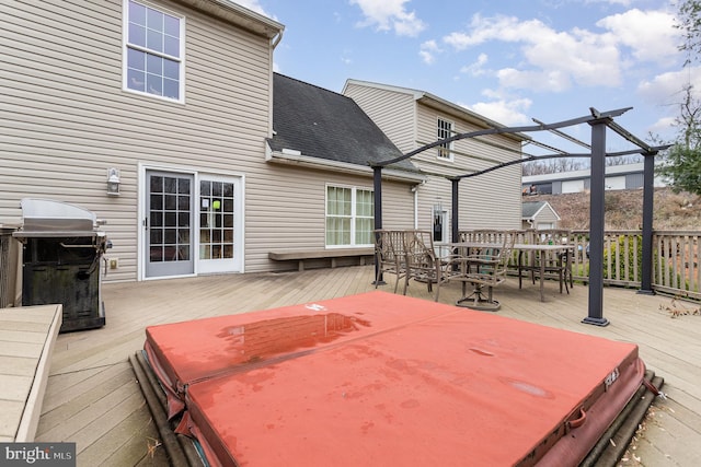 deck with area for grilling, a covered hot tub, and a pergola