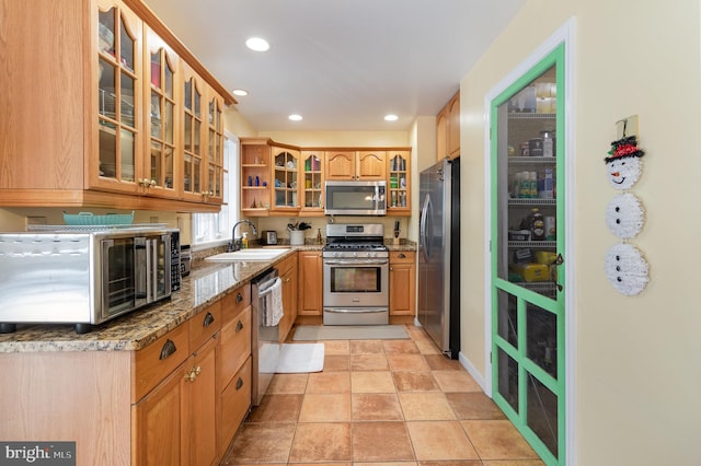 4229 Roundtop Rd, Elizabethtown, PA 17022 - kitchen with stainless steel appliances, glass insert cabinets, open shelves, light stone counters, and recessed lighting