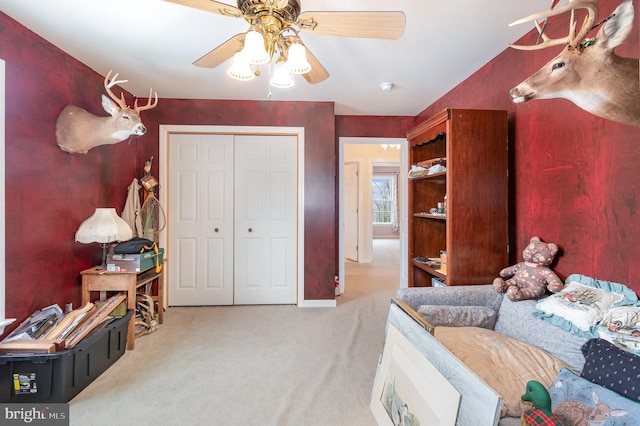 carpeted bedroom featuring ceiling fan and a closet