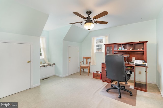 carpeted home office with lofted ceiling and ceiling fan