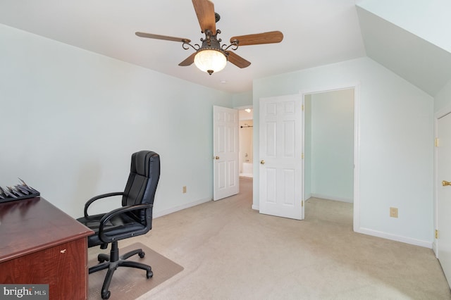 office area featuring lofted ceiling, ceiling fan, and light colored carpet