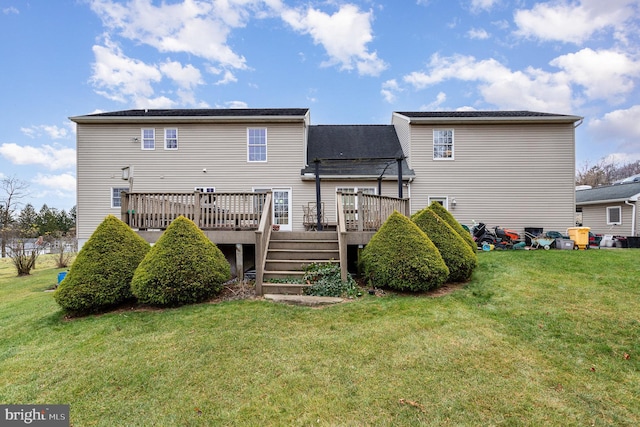 back of property with a deck and a yard