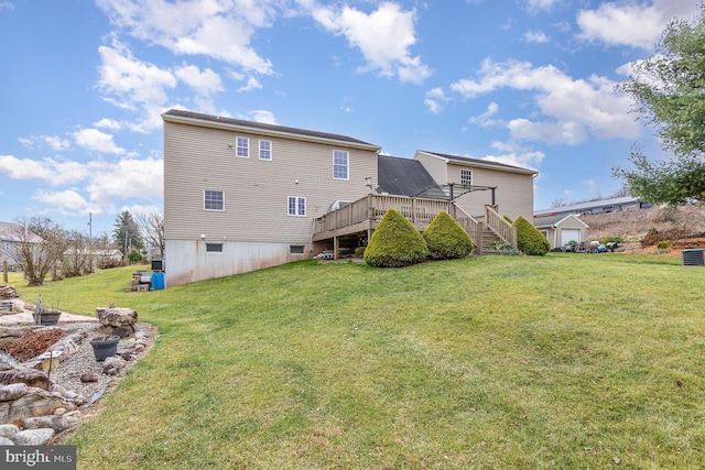 back of house with a lawn and a wooden deck