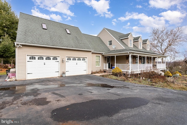 new england style home with a garage and a porch