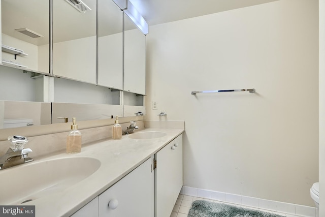 bathroom with tile patterned floors, vanity, and toilet