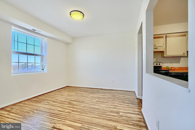 empty room with light hardwood / wood-style flooring