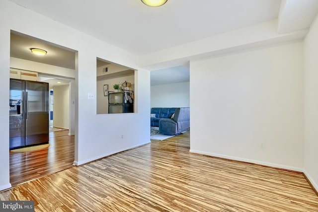 unfurnished room featuring hardwood / wood-style flooring