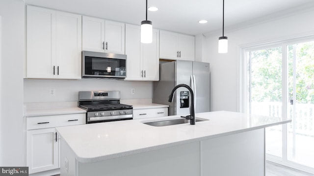 kitchen with sink, a center island with sink, decorative light fixtures, and appliances with stainless steel finishes