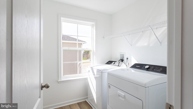 laundry room featuring independent washer and dryer and light wood-type flooring