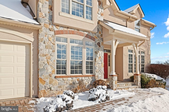 view of snow covered property entrance