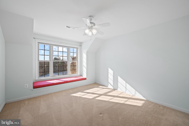 additional living space featuring light colored carpet and ceiling fan