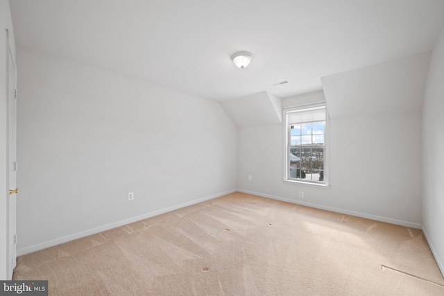 bonus room featuring light carpet and vaulted ceiling