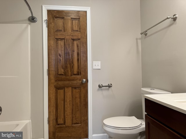 full bathroom with bathtub / shower combination, vanity, and toilet