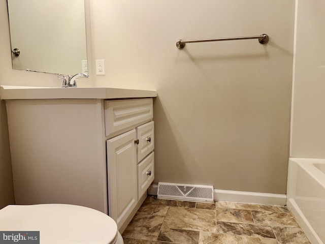 bathroom featuring vanity and toilet