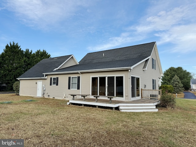 back of property featuring a yard and a wooden deck