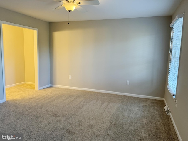 empty room featuring carpet flooring and ceiling fan