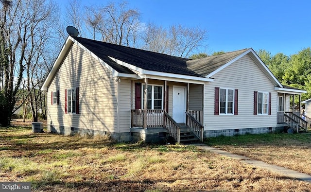 view of front of property with a front lawn and central air condition unit