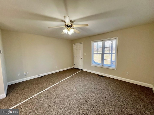 unfurnished bedroom featuring dark carpet and ceiling fan