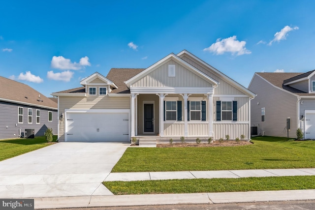 view of front of house featuring a front lawn, a porch, and a garage