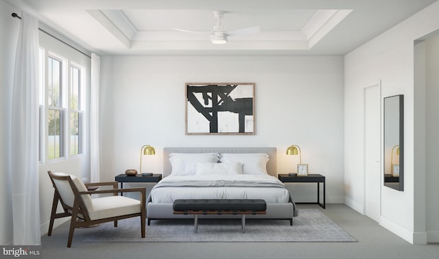 bedroom with carpet flooring, ceiling fan, and a tray ceiling