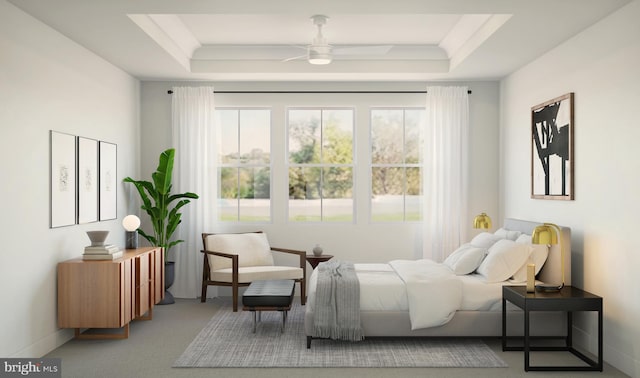 bedroom with carpet floors, a tray ceiling, and ceiling fan