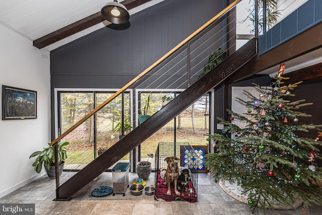 stairs featuring lofted ceiling with beams