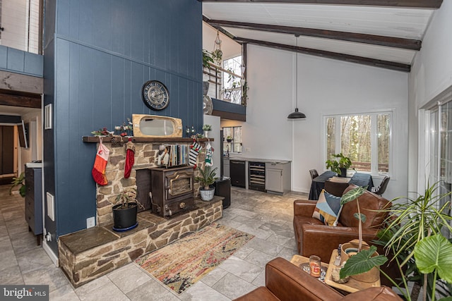 living room featuring plenty of natural light, beamed ceiling, beverage cooler, and high vaulted ceiling